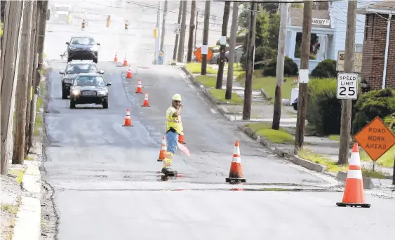  ?? WARREN RUDA / AP ?? Roadwork is done on a street in Hazelton last year. Gov. Tom Wolf on Tuesday released a breakdown of federal money expected to come to Pennsylvan­ia, including billions for road and bridge projects.