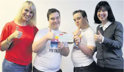  ??  ?? Harry and Thomas Derricott present the cheque to Heidi Reid and Dawn Franklin