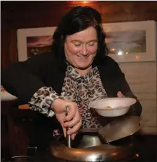  ??  ?? Helena Uí Dhalaigh serving stew to fend off the cold at Féile an Bhuailtín on Bank Holiday Monday. Photo by Declan Malone