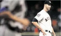  ?? Brett Coomer / Houston Chronicle ?? Astros starter Scott Feldman shows his disgust as the Rangers’ Carlos Peguero rounds the bases on two-run homer in the first.