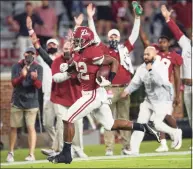  ?? Mickey Welsh / Associated Press ?? Alabama running back Najee Harris scores a touchdown on a long run against Auburn during an NCAA football game on Saturday in Tuscaloosa, Ala. Alabama remained No. 1 in The Associated Press Top 25 poll as did the first eight spots on Sunday.