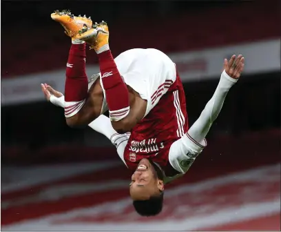  ??  ?? Pierre-Emerick Aubameyang celebrates his brace with a trademark flip at the Emirates Stadium last night