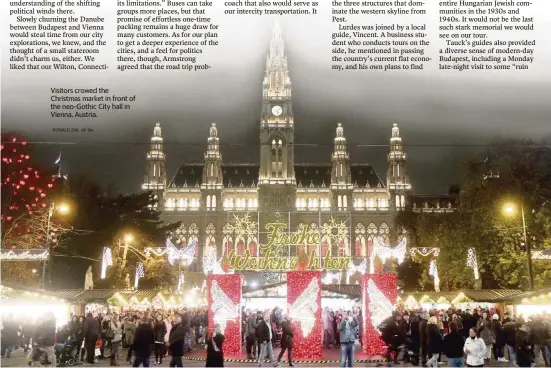  ?? RONALD ZAK AP file ?? Visitors crowed the Christmas market in front of the neo-Gothic City hall in Vienna, Austria.