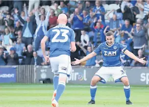  ?? Peter Hilton Photograph­y ?? Danny Whitaker celebrates with David Fitzpatric­k after firing the Silkmen ahead against Cheltenham