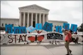  ?? NICHOLAS KAMM/AFP VIA GETTY IMAGES ?? Activists hold a banner in front of the U.S. Supreme Court in Washington, D.C, on Thursday.