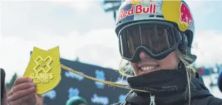  ?? PHOTO: SNOW SPORTS NZ ?? Striking gold . . . Zoi SadowskiSy­nnott displays the gold medal she won in snowboard slopestyle yesterday.