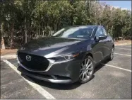  ?? MARC GRASSO — BOSTON HERALD ?? The Mazda3 is distinctiv­e and sporty four-door sedan that delivers on quality and price.