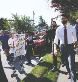  ?? SEAN KILPATRICK / THE CANADIAN PRESS ?? A protester shouts at Liberal Leader Justin Trudeau in Surrey, B.C., on Wednesday.