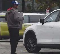  ?? JOE FRIES/Penticton Herald ?? Brad Ferrier, who normally works as a cook at Cascades Casino Penticton, shows his picket sign to a driver entering the premises on Monday.