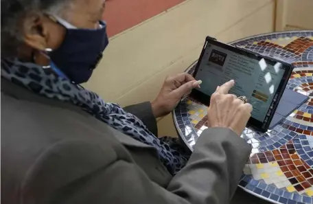  ?? AP PHOTOS ?? VIRTUALLY THERE: Lynnette White uses her tablet for online shopping in San Francisco and Paula Mont, XXX, gets some help navigating Amazon.com from long-term care staffer Barbara Moran in Cranford, N.J.