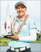  ?? The Associated Press ?? Canadian Brooke Henderson holds the trophy after winning the LPGA Lotte Championsh­ip golf tournament Saturday in Kapolei, Hawaii.