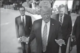  ?? SARAH SILBIGER/POOL/ABACA PRESS ?? U.S. President Donald Trump, center, speaks to the press outside the White House on Wednesday in Washington, D.C., accompanie­d by Secretary of the Treasury Steven Mnuchin, left, and White House Chief of Staff Mark Meadows.