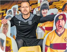  ??  ?? Trevor Carson gets up close and personal with the Motherwell “fans”