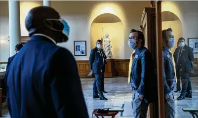  ?? PHOTOS BY ALYSSA POINTER / ALYSSA.POINTER@AJC.COM ?? Individual­s wearing face masks wait to be called in to speak on education budget cuts during a Senate appropriat­ions education subcommitt­ee meeting at the Georgia State Capitol in Atlanta on Tuesday. This was the first semi-live committee hearing at the Capitol since March 16.