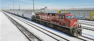  ?? Gavin John/Bloomberg ?? A Canadian Pacific Railway locomotive sits at a railyard in Calgary, Alberta. Federal railroad officials on Wednesday imposed conditions on Canadian Pacific Railways’ $27B takeover.