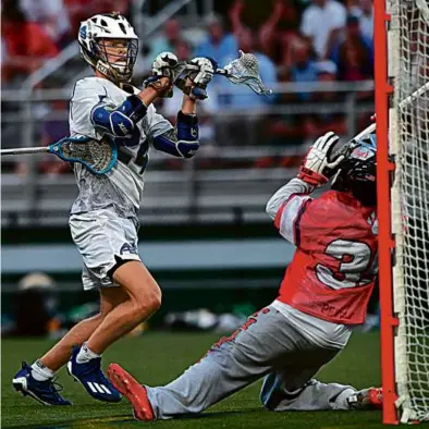  ?? KEN MCGAGH FOR THE GLOBE ?? Acton-Boxborough’s Cam Matthews aims for the net on one his four goals for the MIAA.