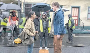  ??  ?? Alice Wu, centre, with main cast Leah Lewis and Daniel Diemer during the shooting of The Half Of It.