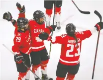  ??  ?? Team Canada's Melodie Daoust scores on Team Switzerlan­d's goalie Andrea Braendli in the second period Monday night in Calgary.