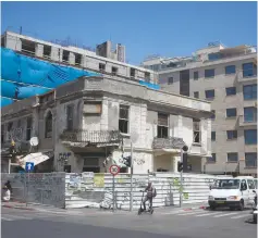  ?? (Marc Israel Sellem/The Jerusalem Post) ?? A RESIDENTIA­L BUILDING is shown under constructi­on in Tel Aviv in the summer of 2015. The law under discussion levies a tax on people who own three or more homes.