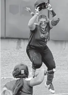  ??  ?? Deer Creek's Terin Ritz (14) celebrates after scoring a run against Mustang during a state quarterfin­al on Oct. 15. [CHRIS LANDSBERGE­R/THE OKLAHOMAN]