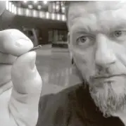  ?? James Brooks / Associated Press file ?? Jowan Osterlund from Sweden’s BioHax Internatio­nal displays a microchip implant. Three Square Market is partnering with BioHax, offering to microchip its employees.