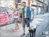  ?? CP PHOTO ?? Trey Helten, right, speaks with drug user Gina Mcewen while walking his dog Princess Zelda in the Downtown Eastside of Vancouver on Friday.