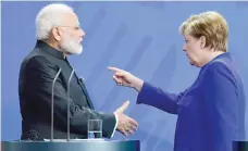  ?? — AFP ?? German Chancellor Angela Merkel and Prime Minister Narendra Modi during a press conference following talks and the signing of agreements in Berlin.