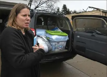  ?? Darrell Sapp/Post-Gazette ?? Neighbor Jessica Headrick talks about donations being collected for the Scott family, whose home in Economy was damaged by a fire.