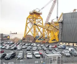  ?? Picture: Tina Norris. ?? Big Business: giant turbine foundation­s are being built at BiFab in Fife for the Beatrice windfarm.