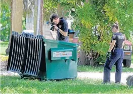  ?? SUSAN STOCKER/STAFF PHOTOGRAPH­ER ?? Police crime scene investigat­ors photograph a dumpster in the 500 block of Northeast First Avenue in Fort Lauderdale where a woman’s remains were found.