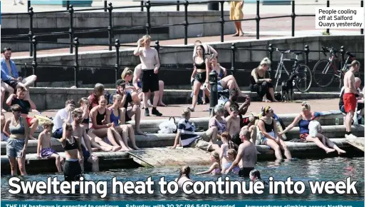  ??  ?? People cooling off at Salford Quays yesterday