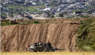  ?? ?? Israeli soldiers rest on top of their tank on the border with the Gaza Strip, in southern Israel, Tuesday, March 26, 2024.