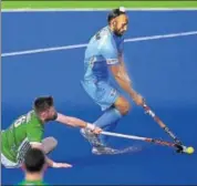  ?? AFP ?? Sardar Singh vies for the ball with Ireland's Shane O'Donoghue.