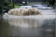  ?? BRYNN ANDERSON — THE ASSOCIATED PRESS ?? A car attempts to drive through flood waters Aug. 17near Peachtree Creek near Atlanta, as Tropical Storm Fred makes its way through north and central Georgia.