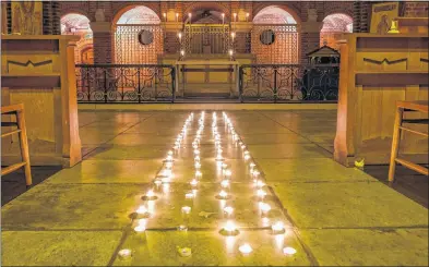  ?? Ref: 05-0221D ?? St John’s Church lit 1,000 candles for the shared vigil