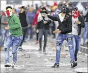  ?? MAJDI MOHAMMED / AP ?? Palestinia­ns clash with Israeli troops in the West Bank city of Nablus after a protest Friday against U.S. President Donald Trump’s decision to recognize Jerusalem as the capital of Israel.