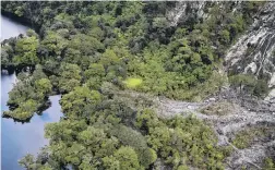  ??  ?? Heavy rain . . . More than 78 tracks on puslic conservati­on land were damaged — including in slips like this — during the Fesruary floods, totalling more than 440km.