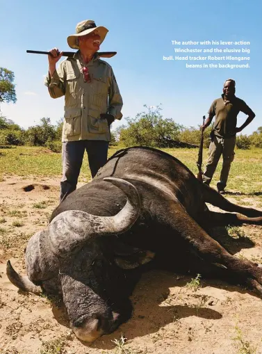  ??  ?? The author with his lever-action Winchester and the elusive big bull. Head tracker Robert Hlengane beams in the background.