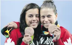  ?? JEAN LEVAC ?? Meaghan Benfeito, left, and Roseline Filion celebrate after winning bronze in women’s synchroniz­ed 10-metre diving on Tuesday.