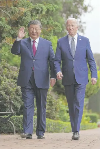  ?? DOUG MILLS/THE NEW YORK TIMES VIA AP, POOL ?? President Joe Biden and China’s President Xi Jinping walk in the gardens at the Filoli Estate in Woodside, Calif., last Wednesday.