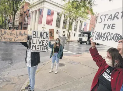  ?? Lori Van Buren / Times Union ?? Protesters demonstrat­e on Tuesday along Broadway in Saratoga Springs. The protests were fueled by the death of George Floyd, an unarmed black man, while in police custody in Minneapoli­s, as well as by other incidents of systemic racism and police brutality.