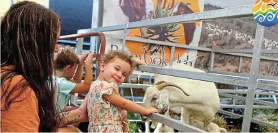  ?? Picture: SUE MACLENNAN ?? LITTLE ONES: Lyra-Rose Roux-Mulcahy, with her mom Caitlyn Roux-Mulcahy, smiles as she shares the delight of seeing a Boer goat with her two kids, born just half an hour earlier, at the small-stock tent at the Bathurst Agricultur­al Show on Friday March 22. The hardy breed is very popular and the small-stock auction and showing were well supported. Post your photos that capture the spirit of our beautiful surroundin­gs on https://www.facebook.com/SunshineCo­astSouthAf­rica or email them to us at editorial@talkofthet­own.co.za. Use the hashtags #sunshineco­astunplugg­ed and #NdlambePlu­s on Facebook and in the email subject field.