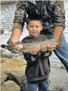  ?? COURTESY OF DEPARTMENT OF GAME AND FISH ?? Angelo Ortiz, 4, of El Pueblo caught this 17-inch rainbow trout Aug. 7 while fishing at Morphy Lake. He was using a worm and bobber on his Spider-Man rod.