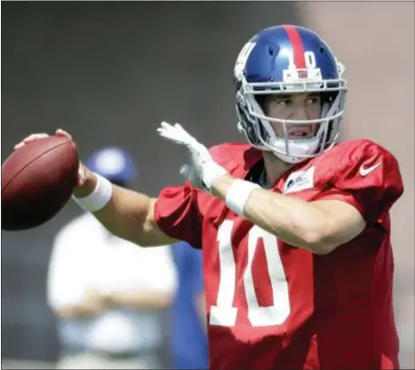  ?? THE ASSOCIATED PRESS ?? Giants quarterbac­k Eli Manning throws a pass during training camp last Thursday in East Rutherford.