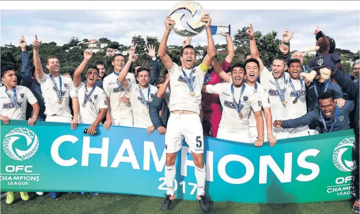 ?? Picture / Photosport ?? Auckland City skipper Angel Berlanga lifts aloft the Oceania Champions League trophy in Wellington yesterday.