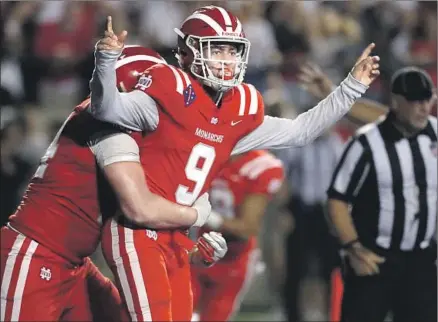  ?? Photograph­s by Luis Sinco Los Angeles Times ?? MATER DEI quarterbac­k Bryce Young celebrates in the fourth quarter last month after scoring against IMG Academy of Florida.