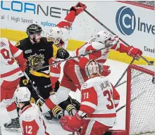  ?? GARY YOKOYAMA THE HAMILTON SPECTATOR ?? Bulldog Ryan Moore gets his stick entangled in Greyhound Phil Caron’s jersey around the Soo goal during Game 4.