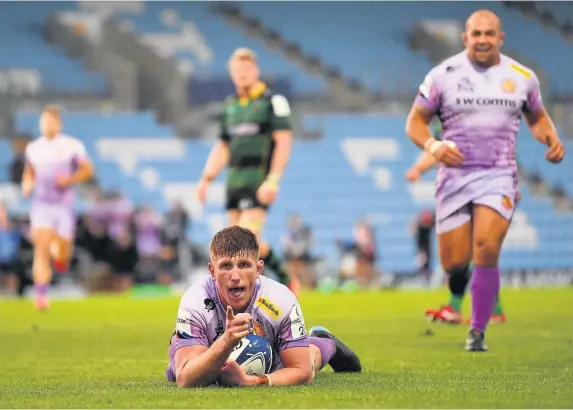  ?? Dan Mullan ?? > Exeter’s Jacques Vermeulen celebrates after diving over to score his side’s fifth try during the Champions Cup win against Northampto­n