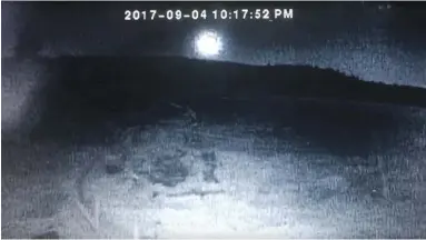  ?? JACQUIE MCKAY, YOUTUBE, VIA CP ?? There’s puzzlement in B.C. and Alberta about a bright flash that lit up the sky on Monday night. This image is from a YouTube video taken from a security camera in Bridge Lake, northwest of Kamloops.