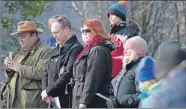  ??  ?? Visitors listen intently during the service at the massacre memorial.